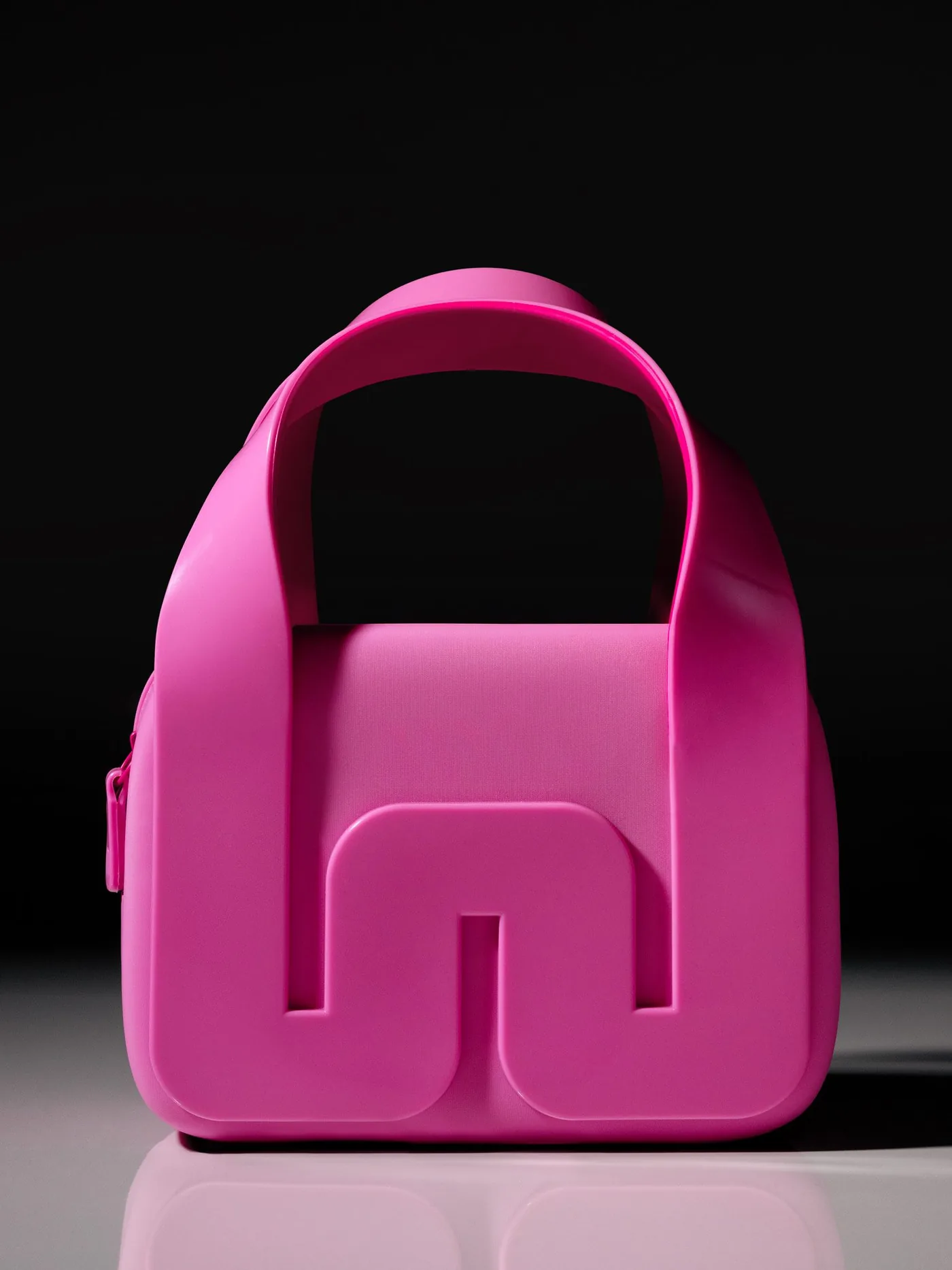 A pink Melissa bag with the new monogram as its clasp
